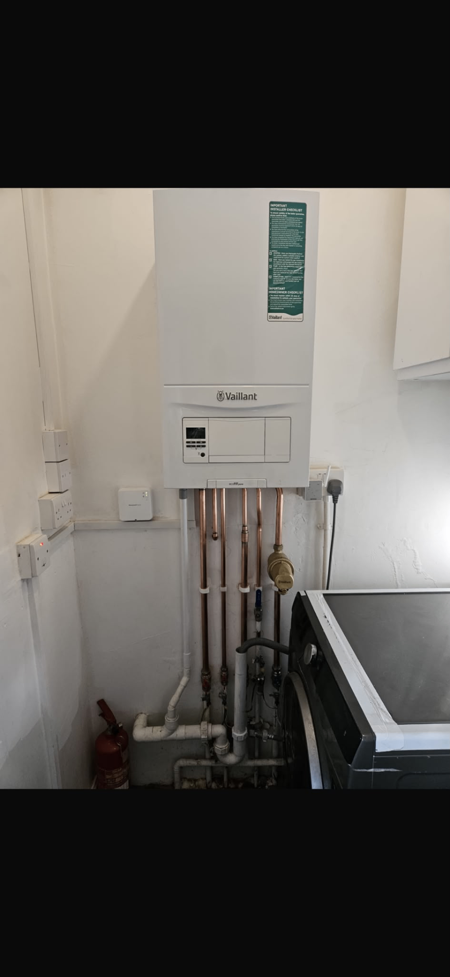 Vaillant boiler fitted in a utility room with tidy vertical pipework connections